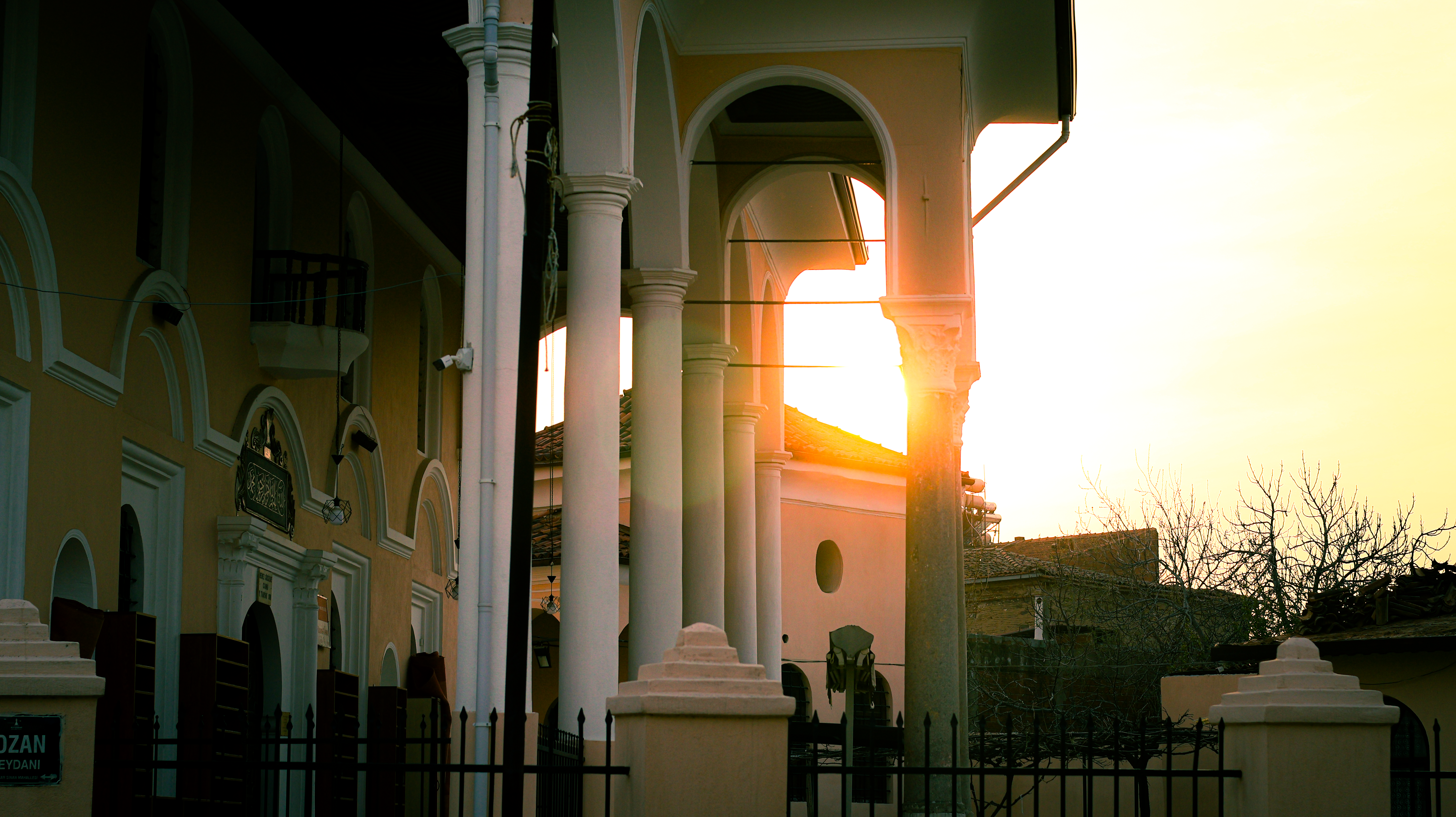 Elegant columns illuminated by sunset, creating a serene architectural scene.