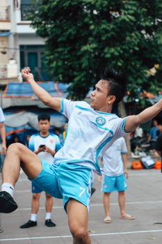 Male players passionately engaged in a vibrant street soccer game outdoors.