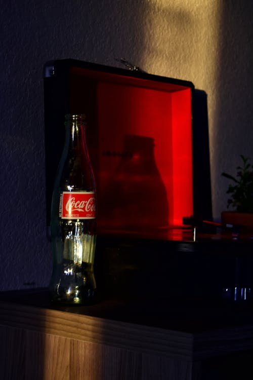 Coca Cola Glass Bottle on Brown Wooden Table