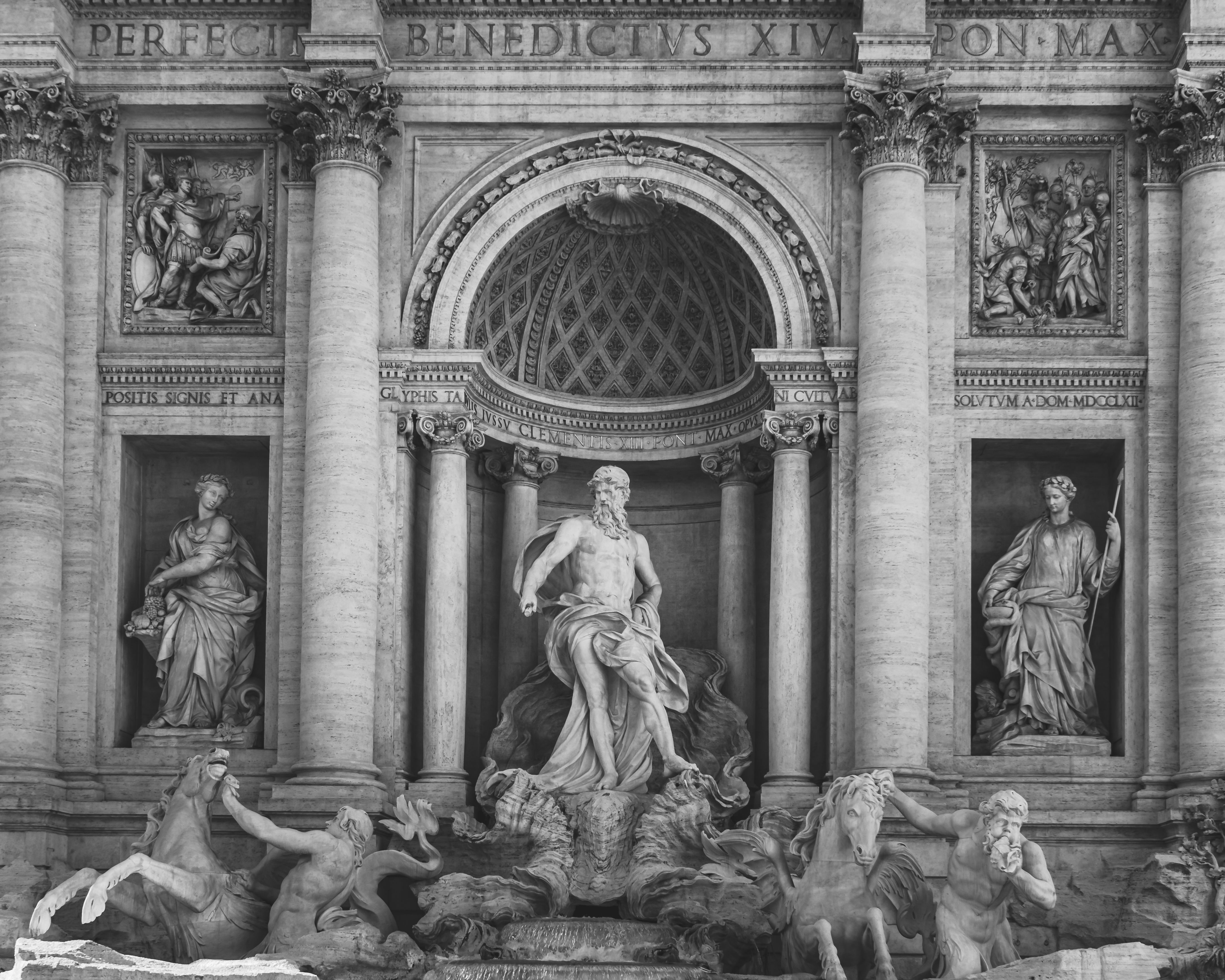 Black and white close-up of the Trevi Fountain's intricate sculptures in Rome, Italy.