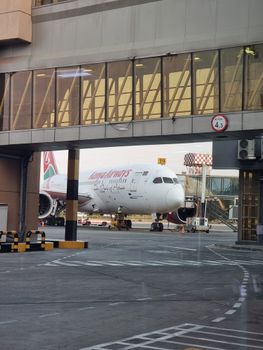 Kenya Airways Boeing 787 at Nairobi Airport gate with boarding bridge.