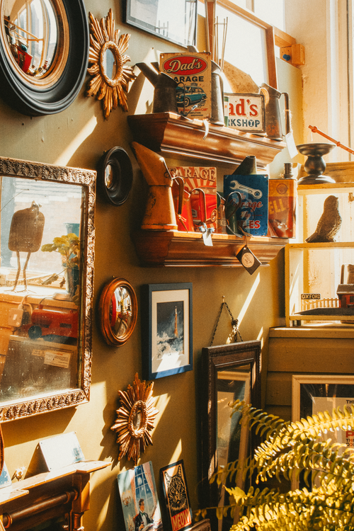 Free Sunlit wall with vintage decor and antiques in a Shrewsbury shop, capturing a nostalgic aesthetic. Stock Photo