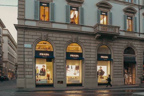 Free A stylish view of a Prada store facade in Florence, Italy, during evening hours. Stock Photo