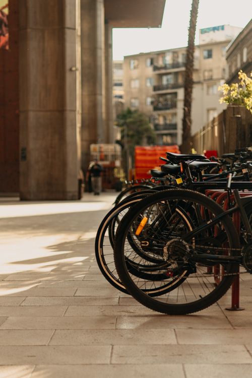 Free Bicycles lined up on a sunny street in Santiago, Chile, creating a modern urban scene. Stock Photo