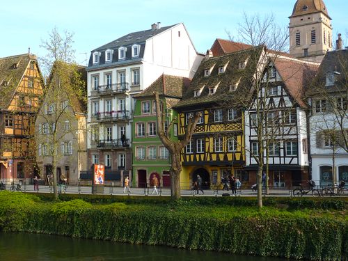 Free Historic half-timbered houses line the canal in Strasbourg, France, showcasing classic Alsatian architecture. Stock Photo