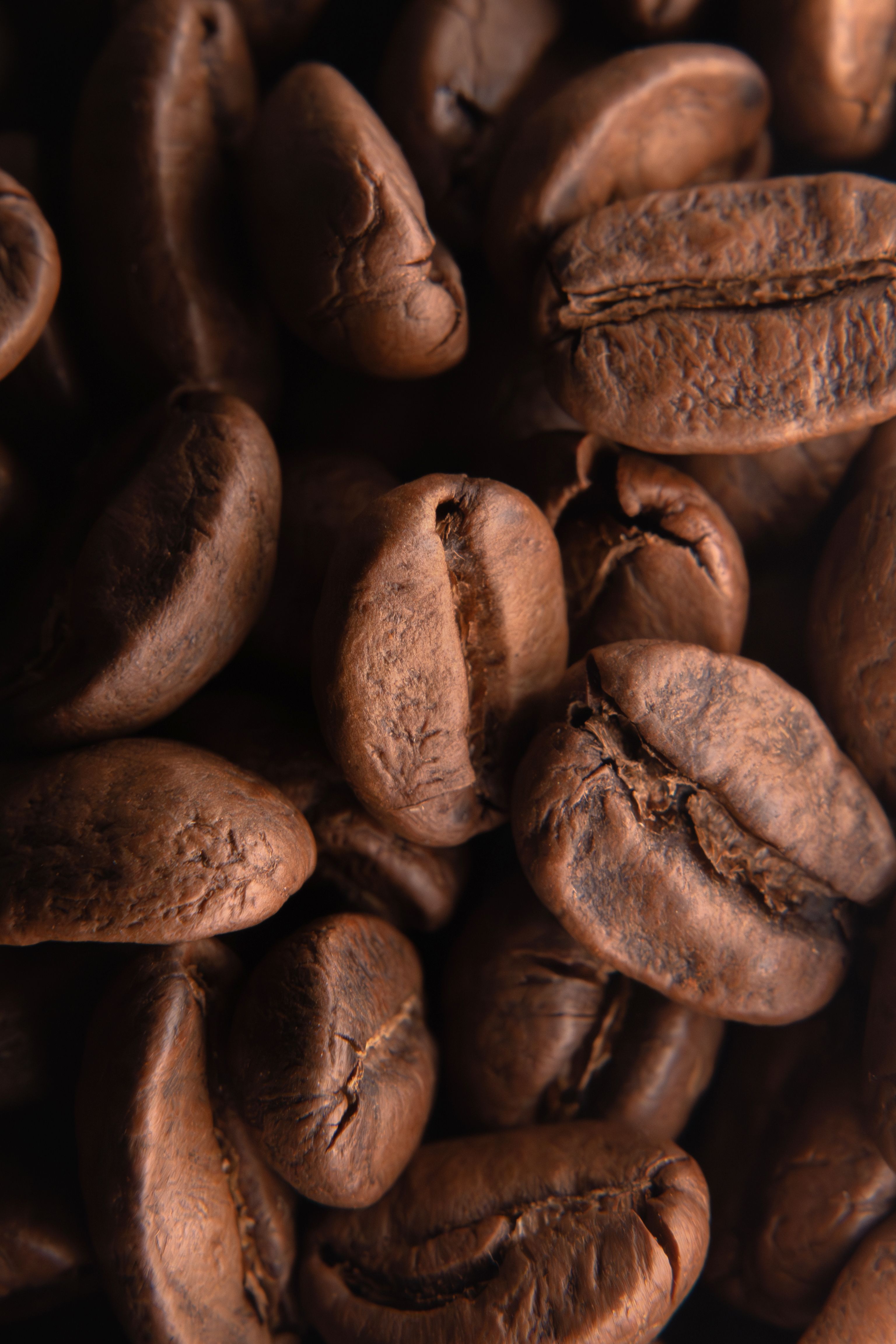 Detailed shot of roasted coffee beans, highlighting their texture and rich color.