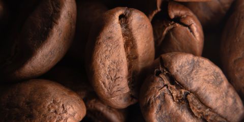 Detailed shot of roasted coffee beans, highlighting their texture and rich color.