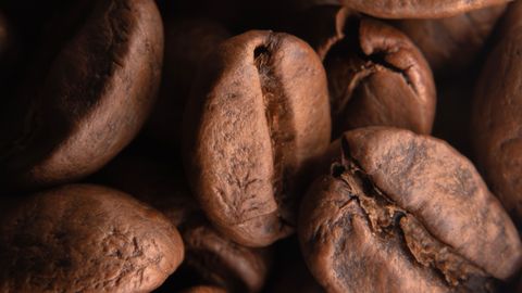 Detailed shot of roasted coffee beans, highlighting their texture and rich color.