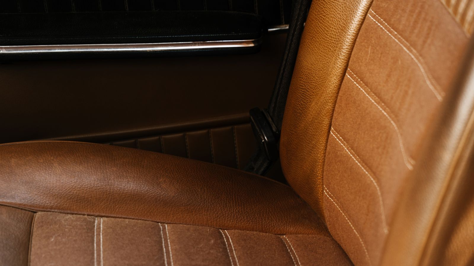 Detalhe do desgaste na lateral do banco do motorista de um carro usado