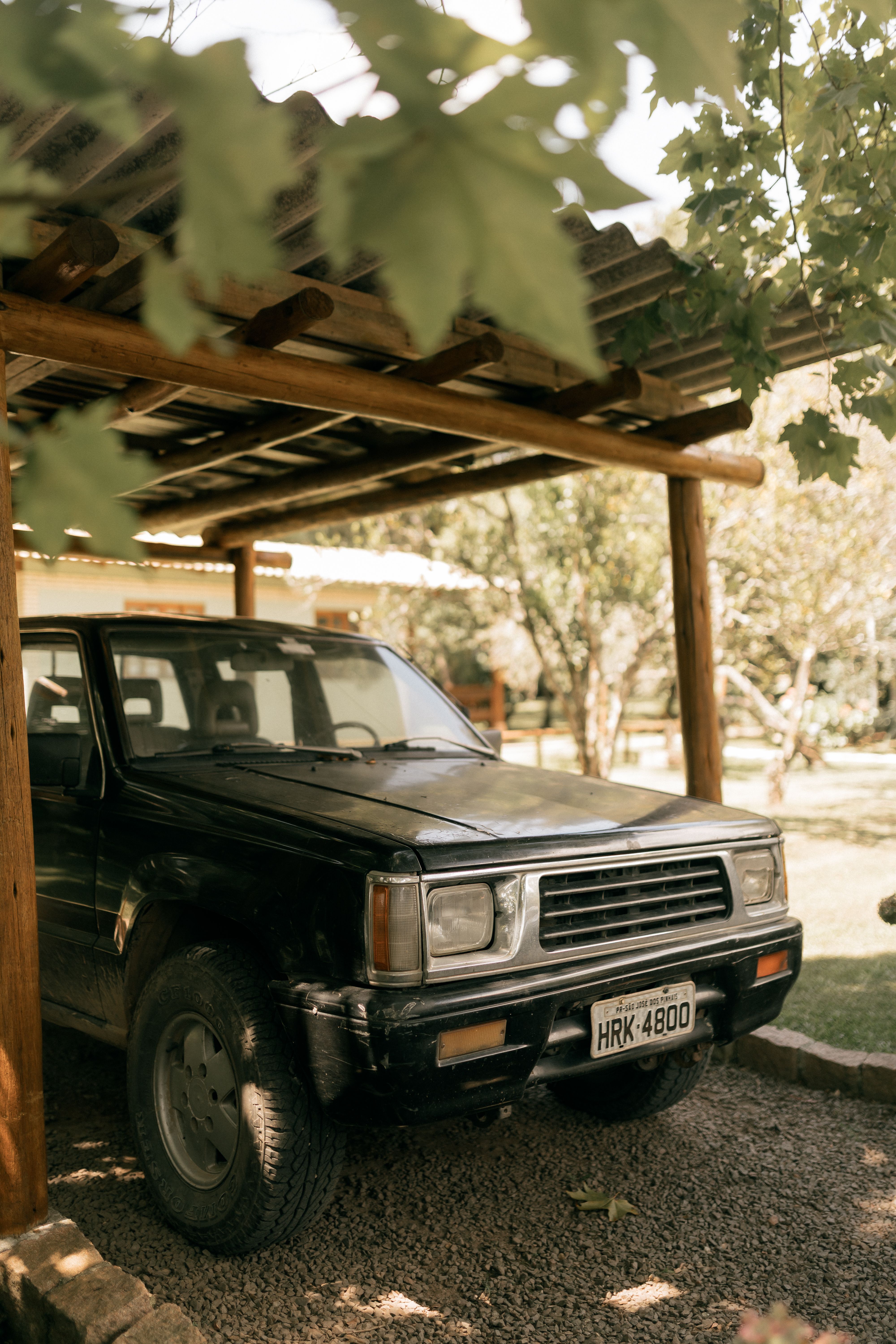 Vintage Truck Parked Under Wooden Canopy · Free Stock Photo