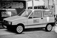 A classic Fiat car displayed at a vintage exhibition in Tuscany, Italy.