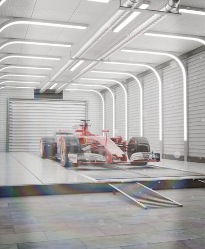 Red Formula One car in a garage