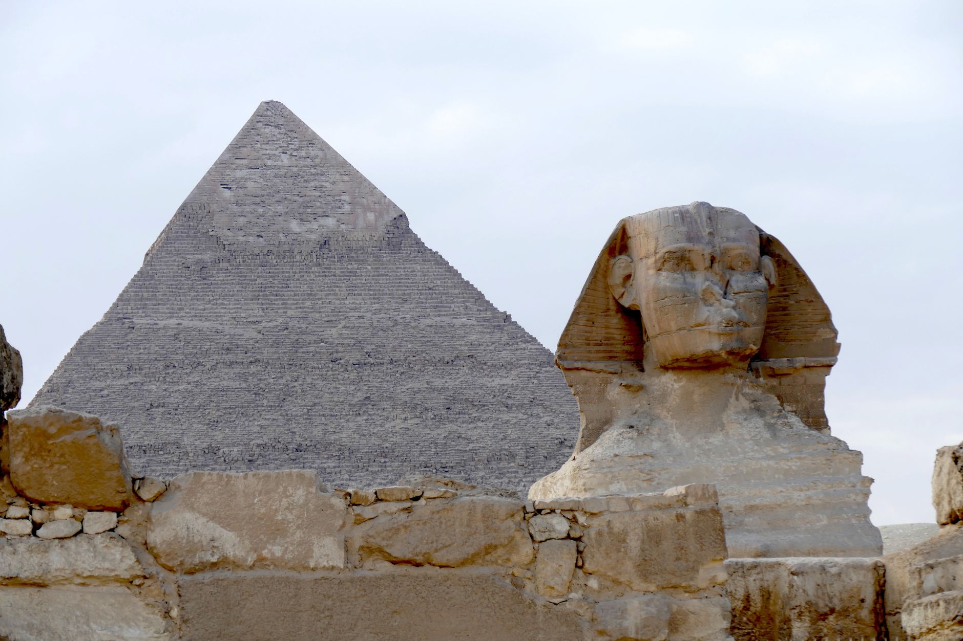 The iconic Great Pyramid and Sphinx of Giza captured on a clear day, highlighting ancient Egyptian architecture.