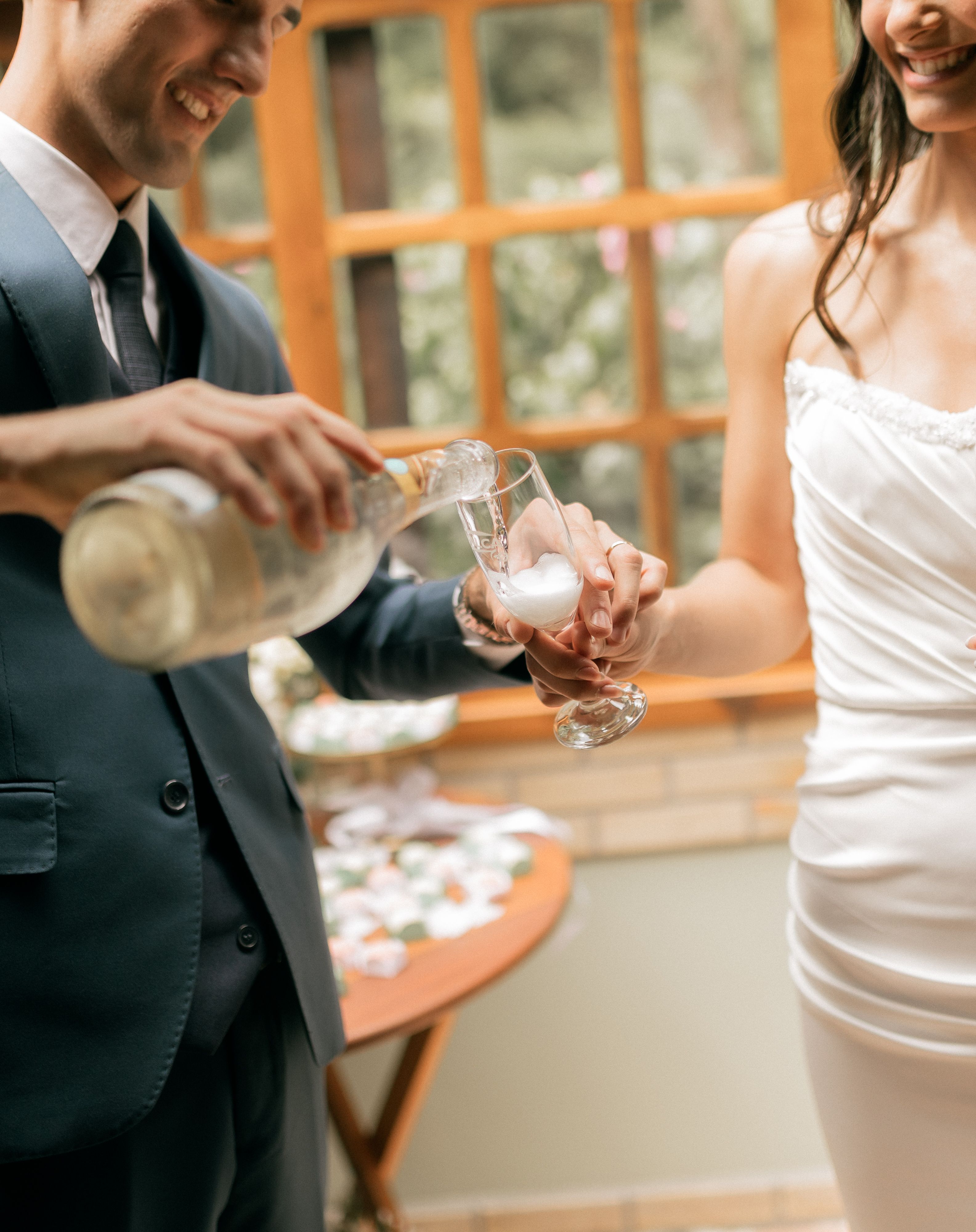 Bride and groom sharing a celebratory toast during their wedding ceremony.
