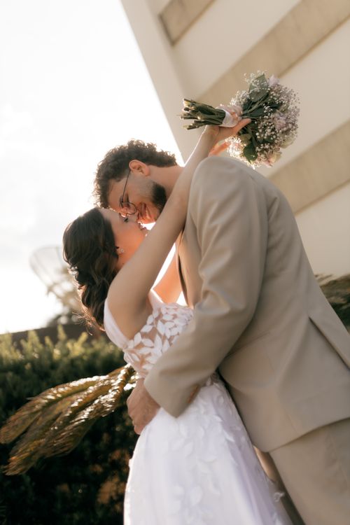 Free A couple shares a romantic embrace outdoors, capturing the essence of love at sunset. Stock Photo