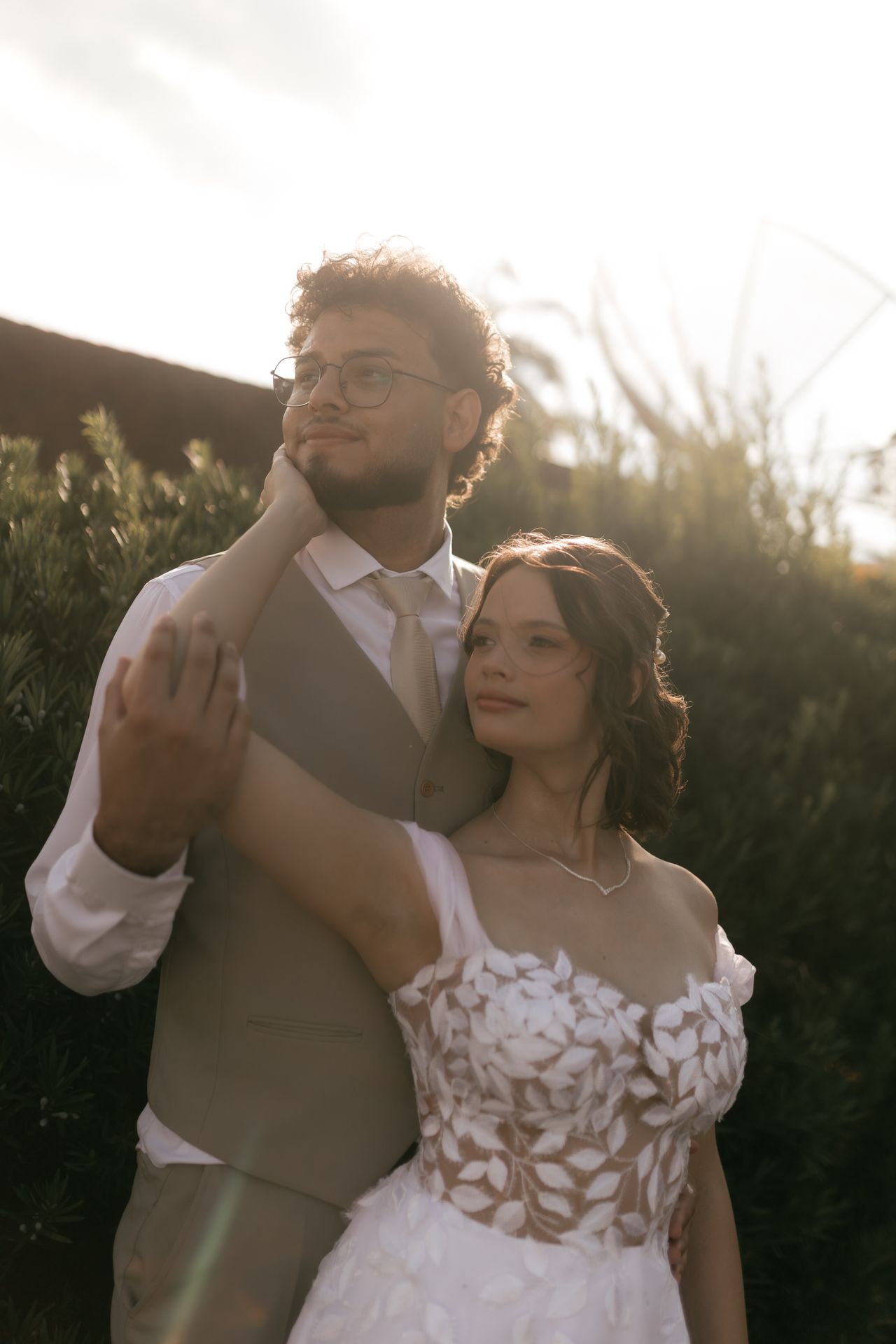 Wedding couple embracing outdoors at golden hour