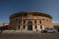 An iconic bullring structure in Orán, Algeria, captured in a daylight setting.