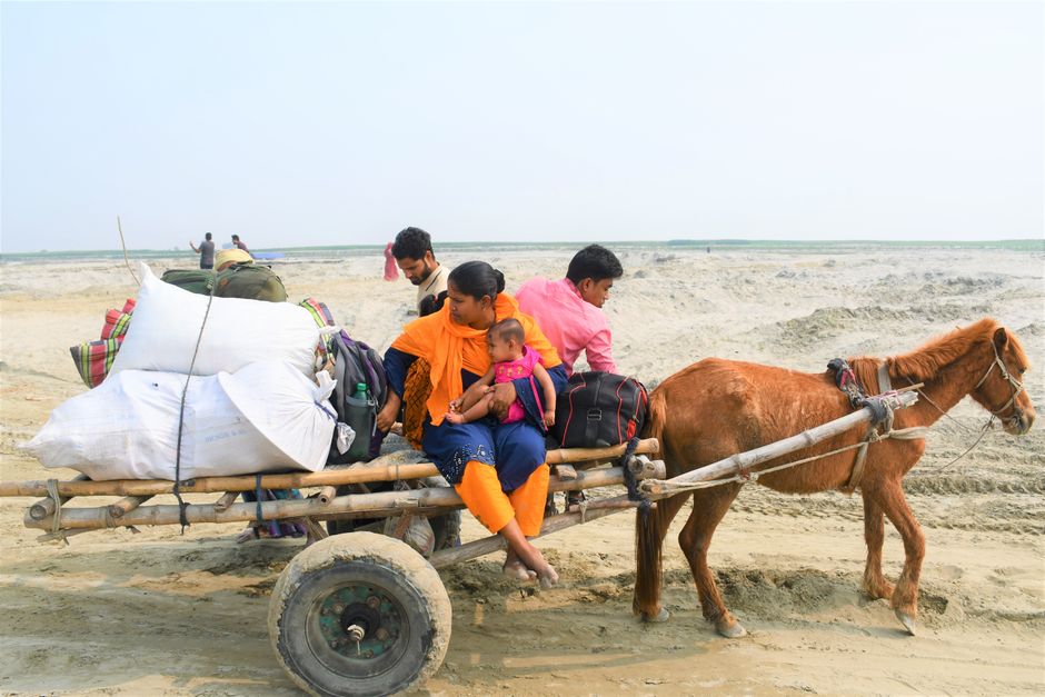 A family travels on a horse-drawn cart across a sandy landscape in Rangpur Division, Bangladesh. A family travels on a horse-drawn cart across a sandy landscape in Rangpur Division, Bangladesh.