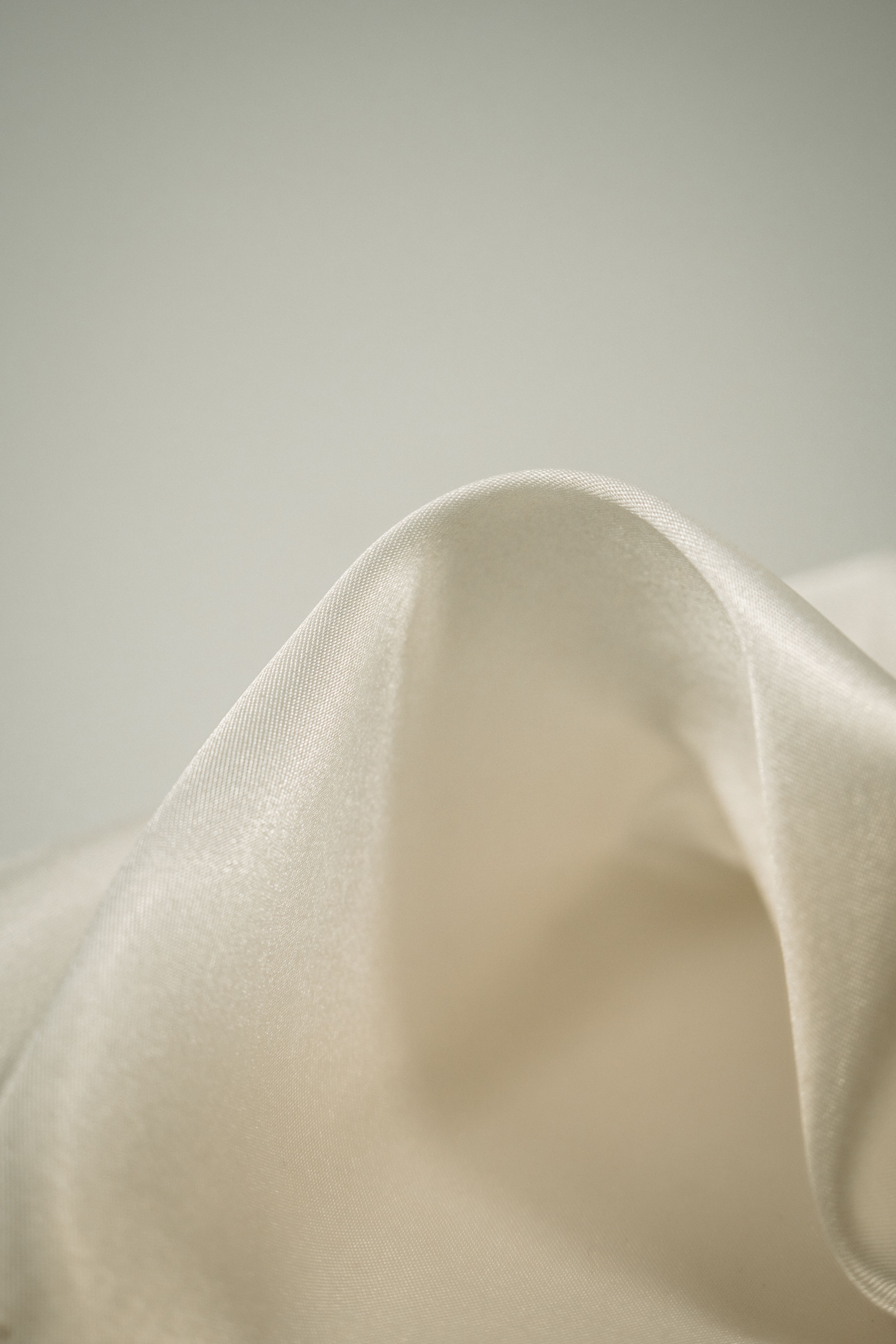 Lune silk scarf in ivory, showing the fluid twill drape