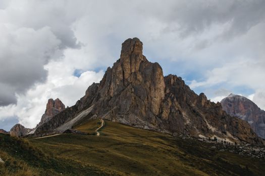 Stunning view of the Dolomites mountains with dramatic clouds overhead. Perfect for travel and nature themes.