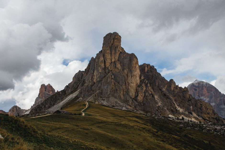Stunning view of the Dolomites mountains with dramatic clouds overhead. Perfect for travel and nature themes.