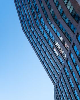 Sleek glass facade of a high-rise condo in downtown Toronto, Ontario.