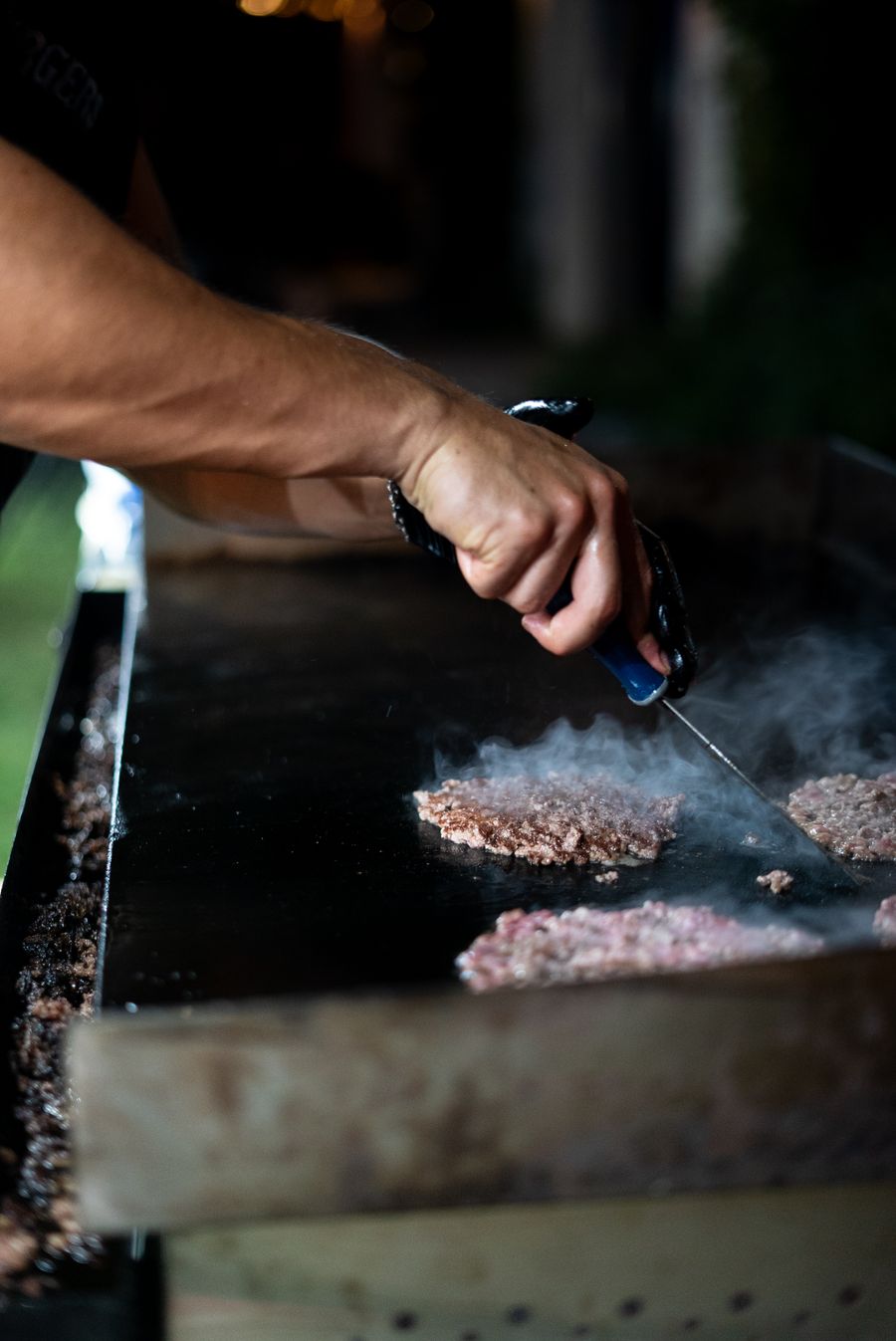 Angus beef patties smashed on the Ember Bird griddle