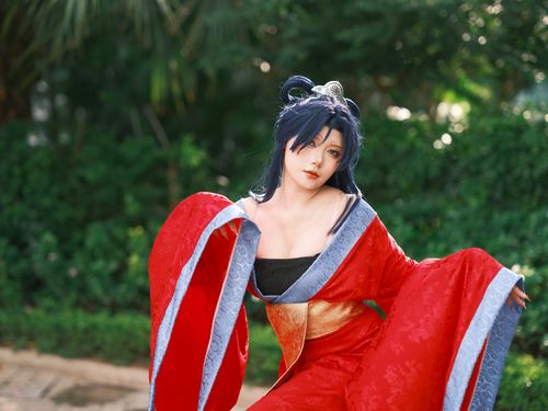 Free A cosplayer in a red kimono poses gracefully outdoors, showcasing detailed costume and vibrant colors. Stock Photo