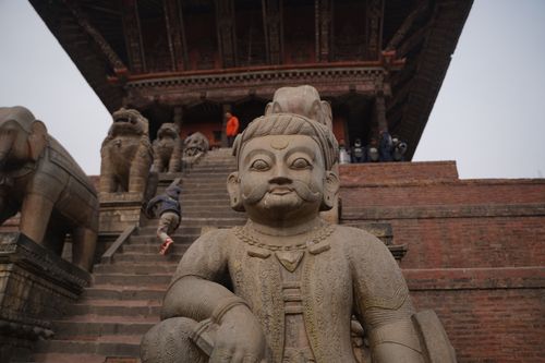 Free Stone guardian statues at a historic temple entrance, capturing cultural heritage. Stock Photo