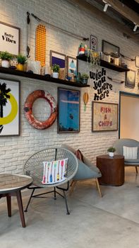 Modern lounge with coastal decor elements, featuring nautical details and vibrant artwork.