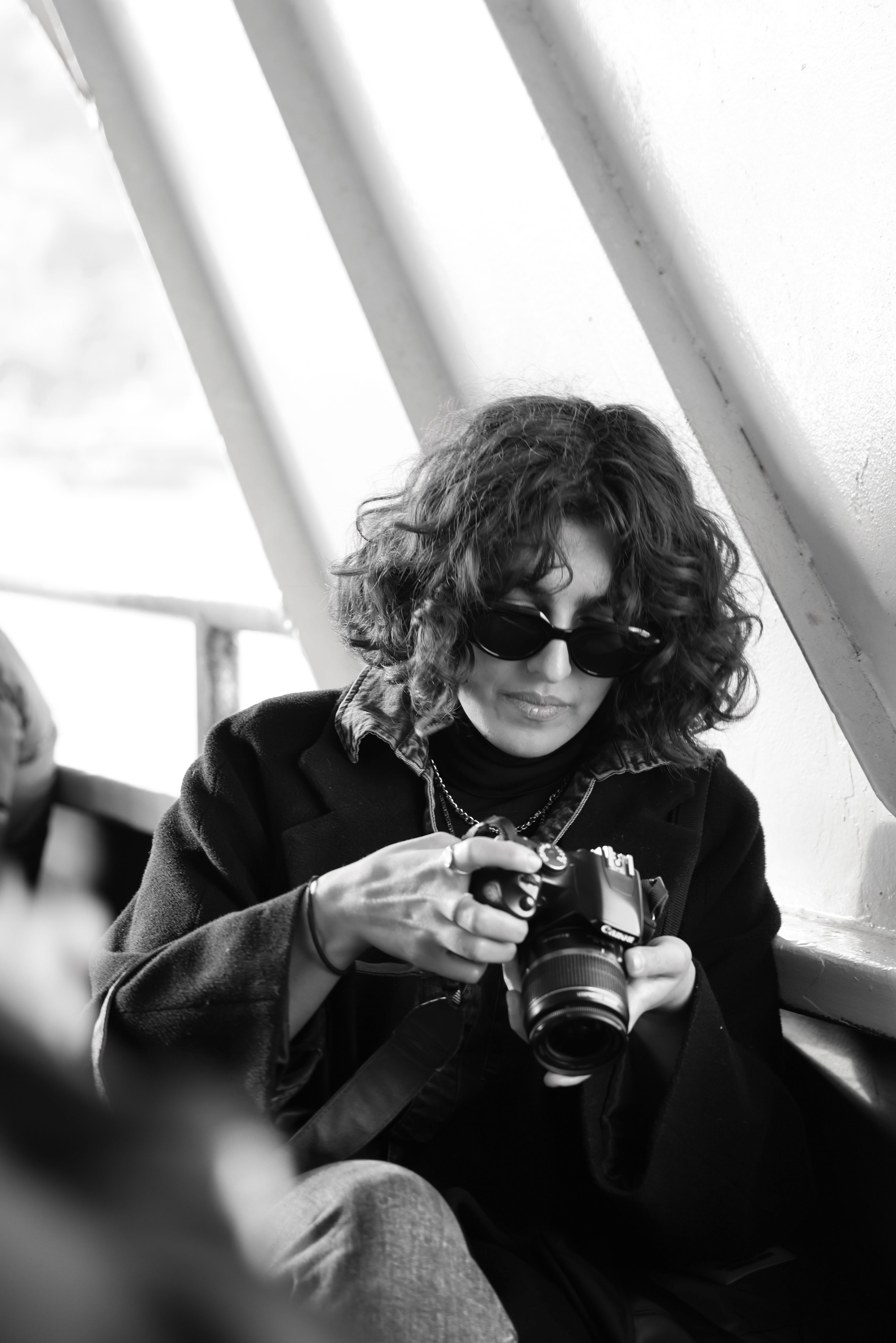 Fashionable Woman Inspecting Camera on a Trip · Free Stock Photo