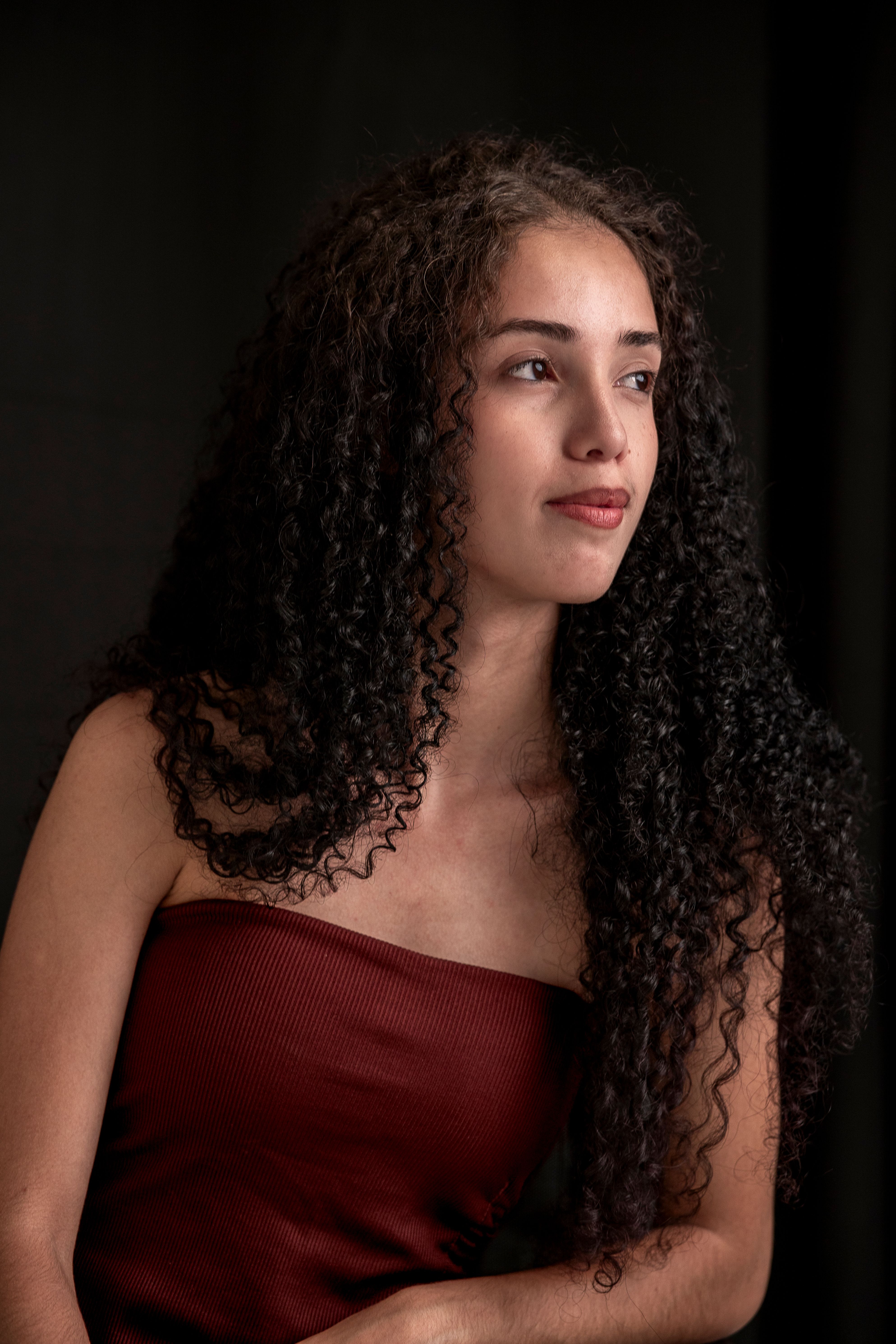Elegant Portrait of Woman with Curly Hair · Free Stock Photo
