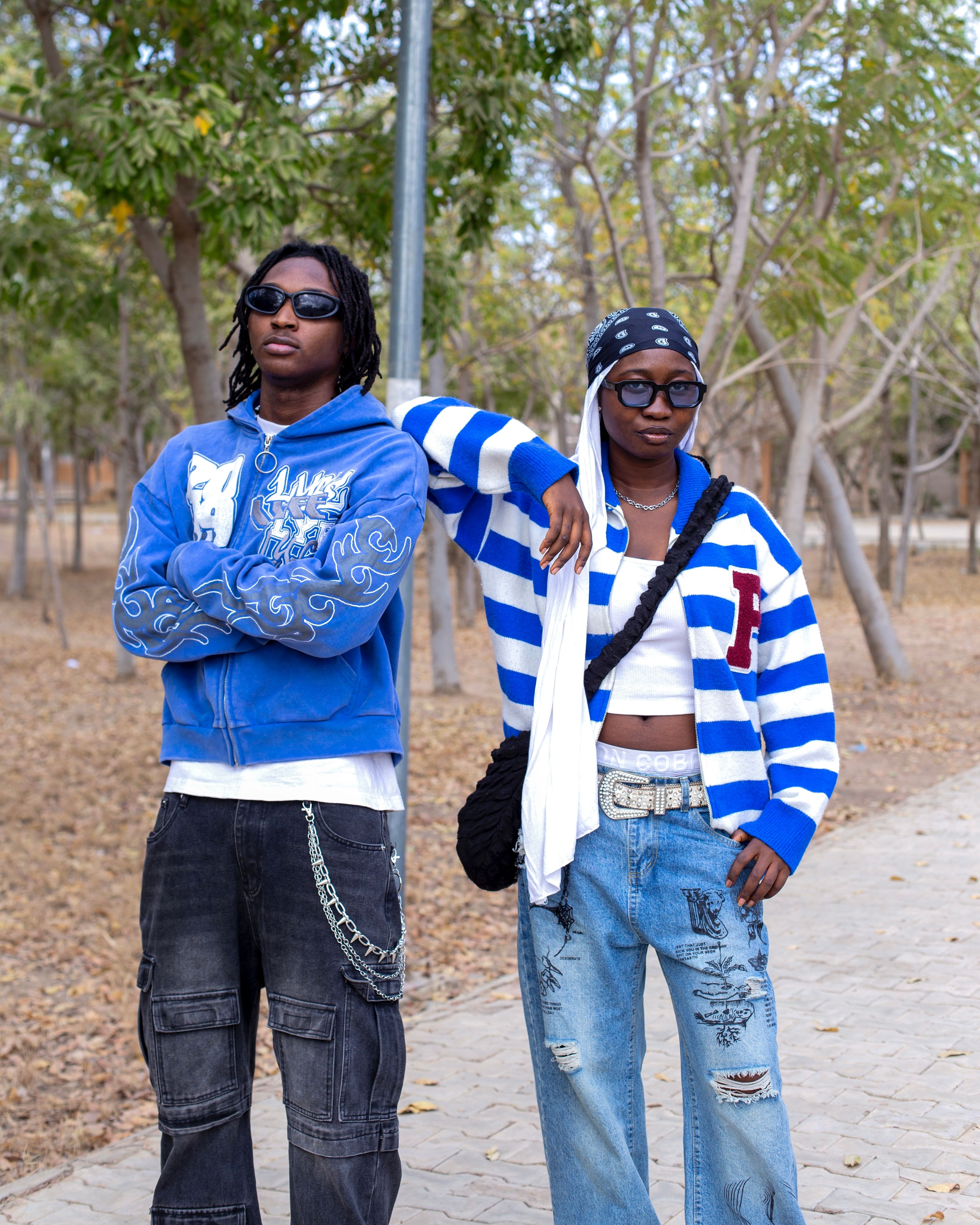 Two stylish young adults in casual outfits enjoying an autumn day outdoors.