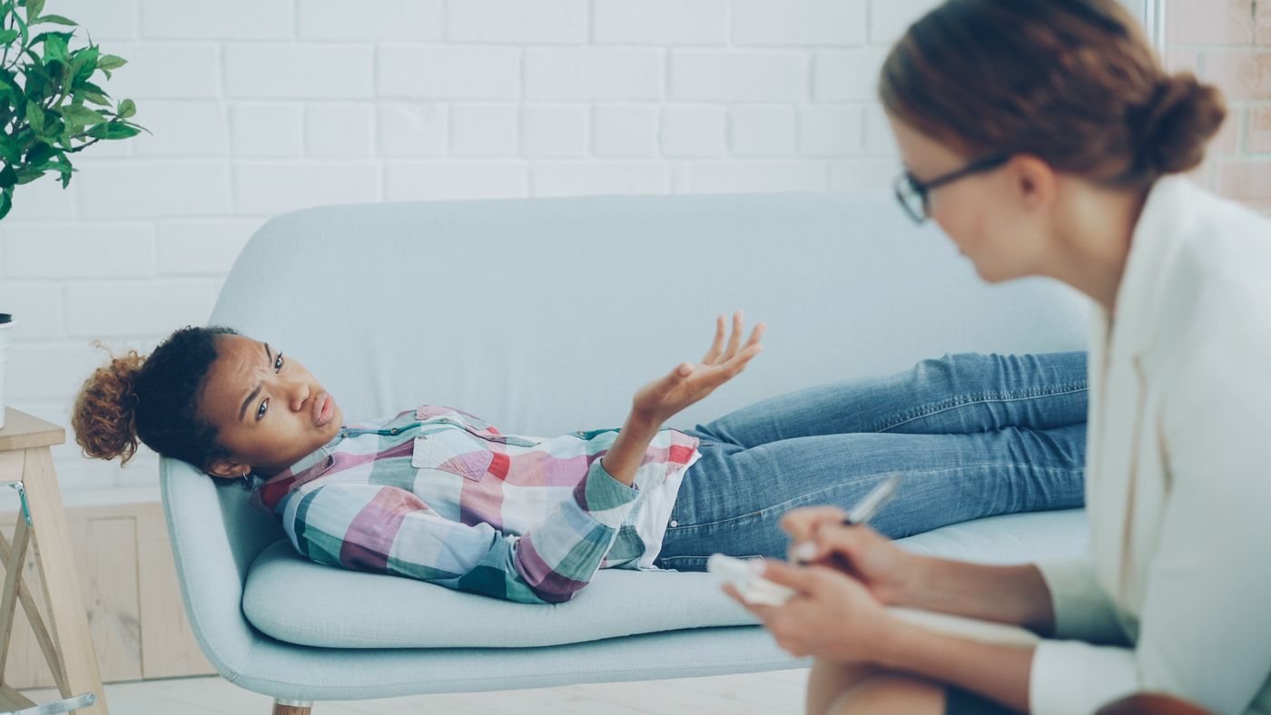 Adult patient discussing attention and organization concerns with a mental health professional