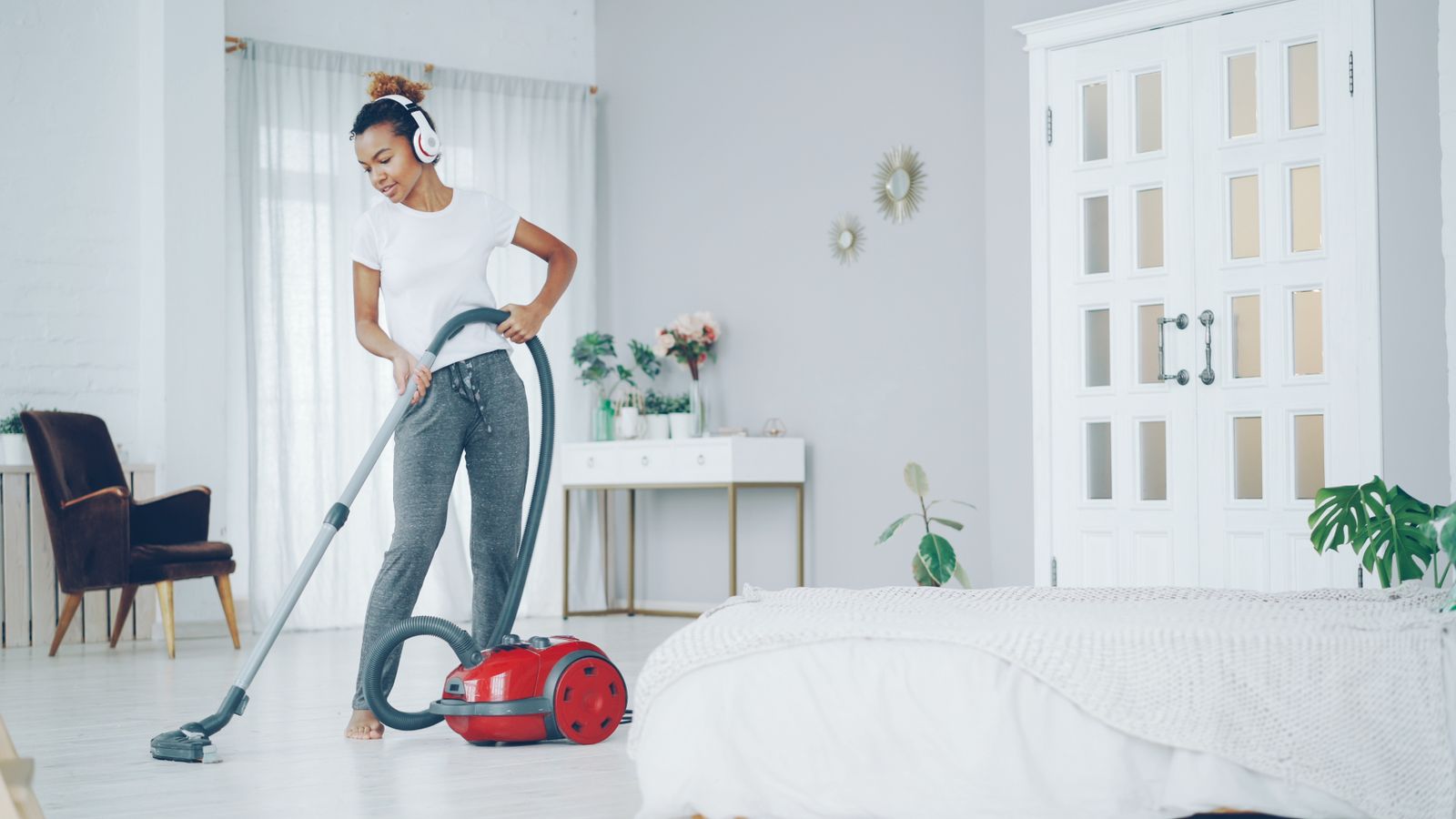 Professional cleaner vacuuming a modern home
