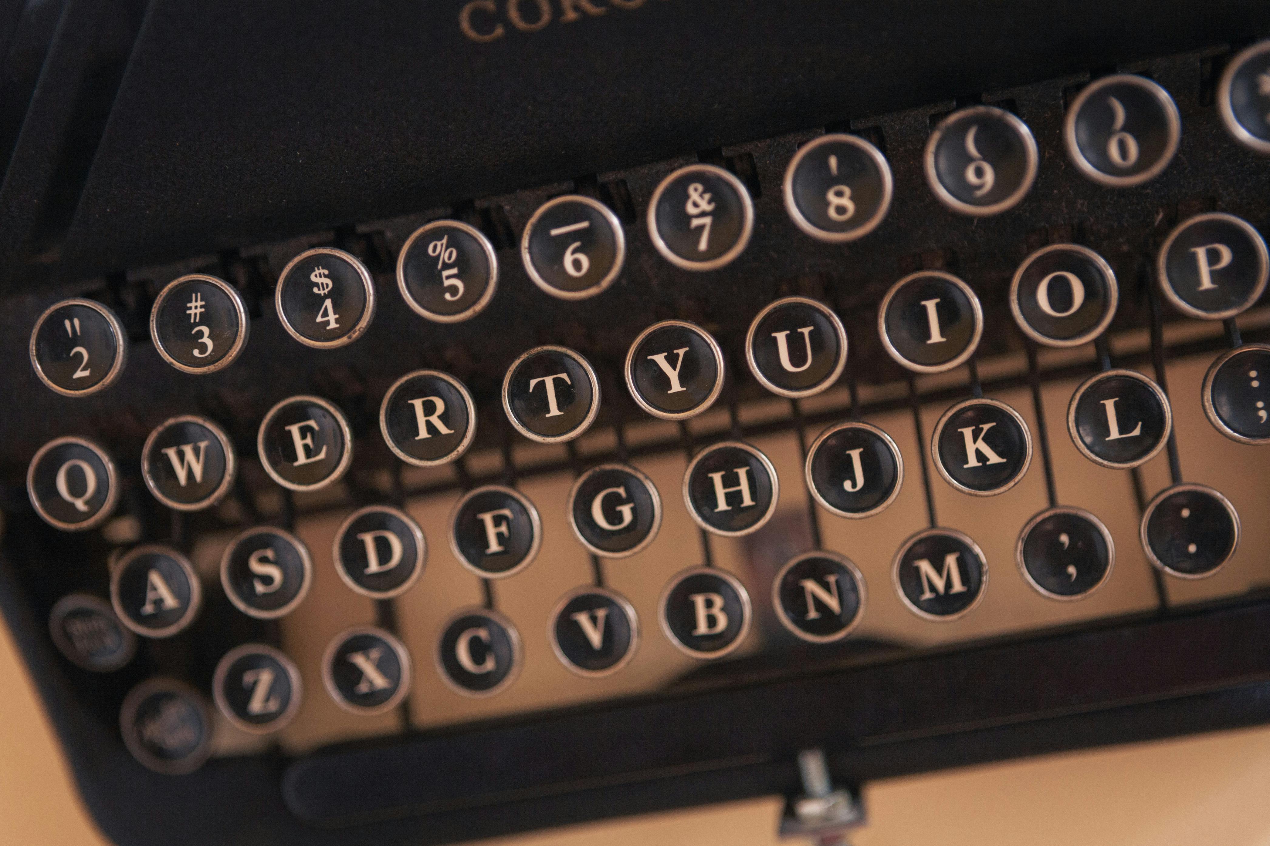 Detailed view of a classic typewriter keyboard displaying letters and symbols.