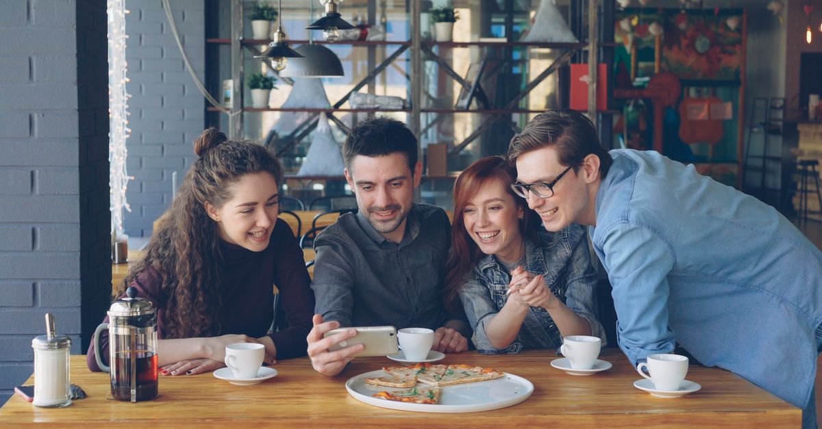 people laughing together at a cozy bookstore cafe