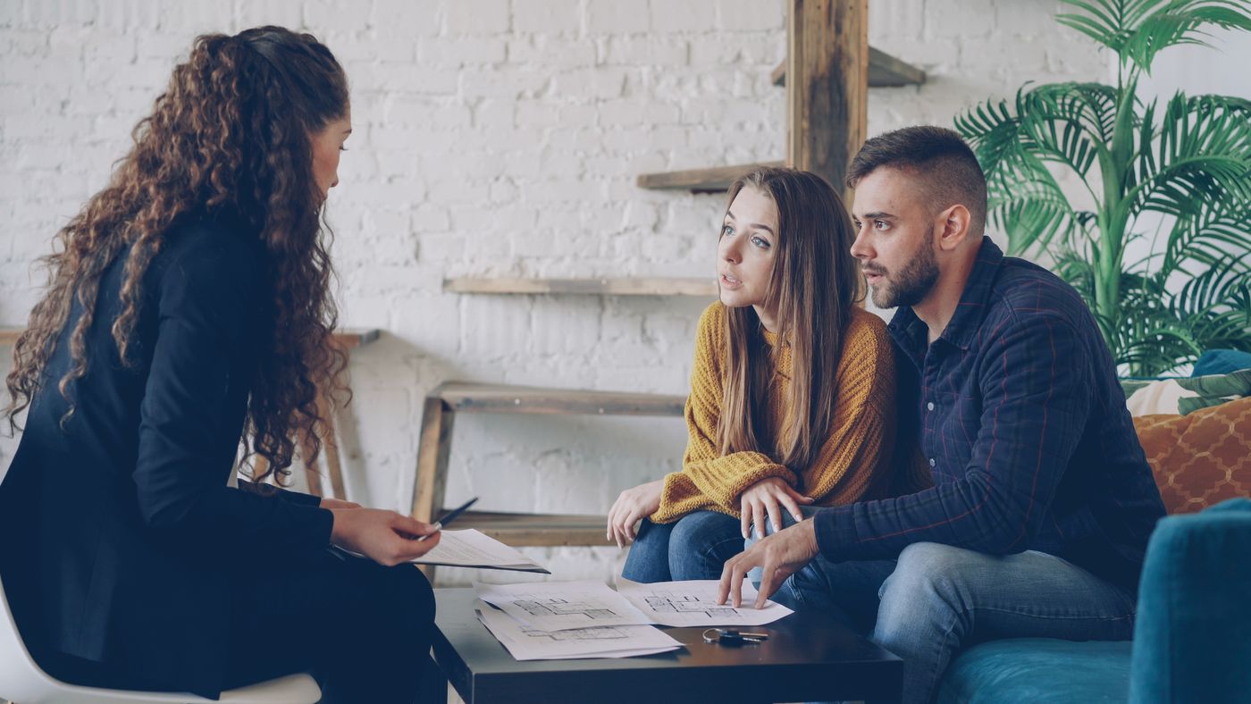 Business consultant discussing plans and documents with clients