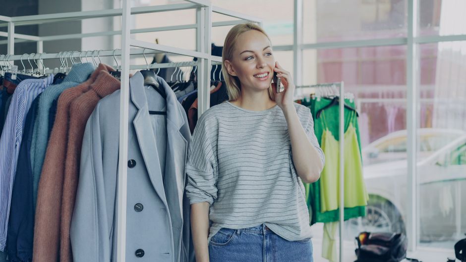 Business owner reviewing customer feedback software results on a phone