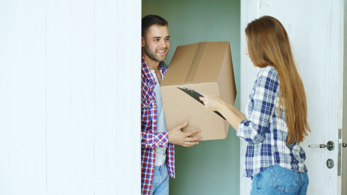 Customer handing a cardboard package back during an exchange