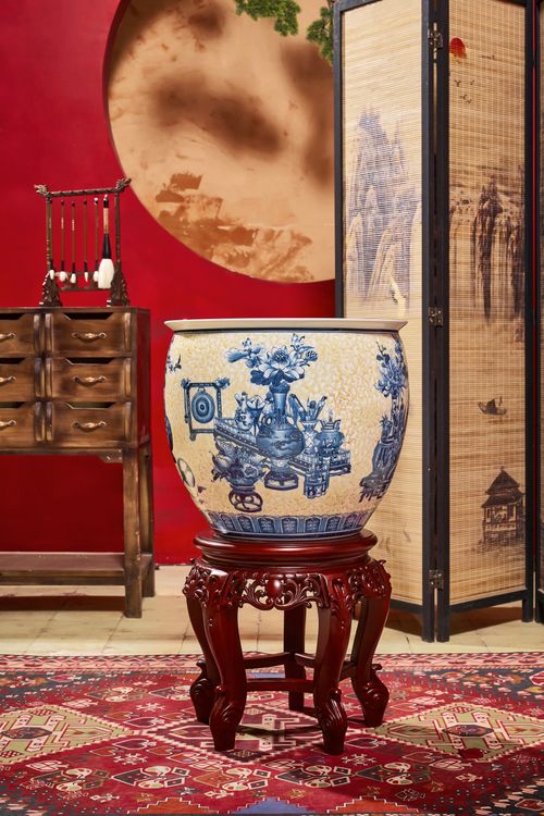 Free Sophisticated interior featuring a traditional blue and white ceramic vase with oriental furniture. Stock Photo