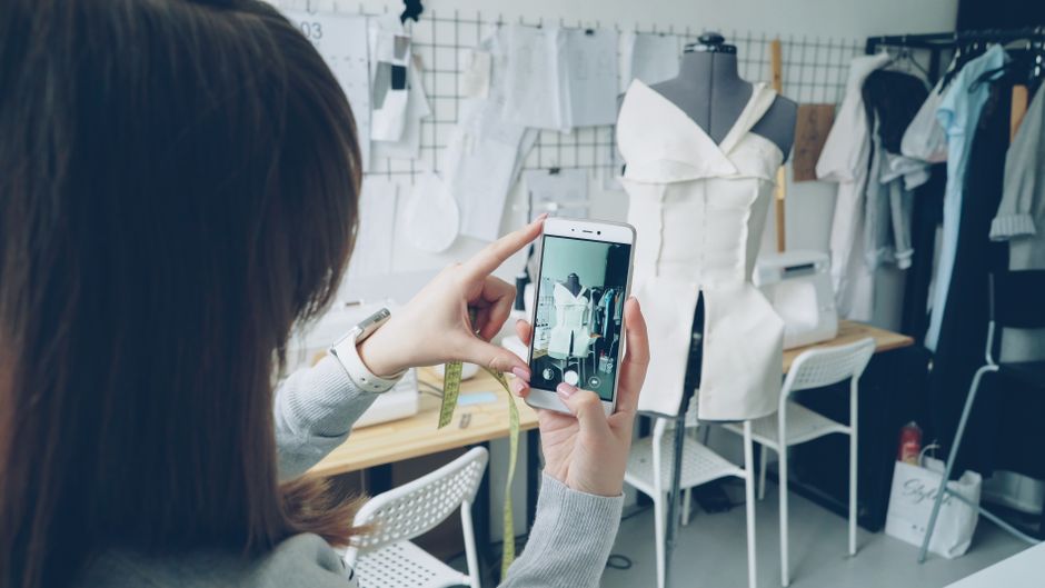 Thermapen ONE vs ThermoPro: Instant Read Thermometer Accuracy Showdown Fashion designer captures dress design using smartphone in atelier.