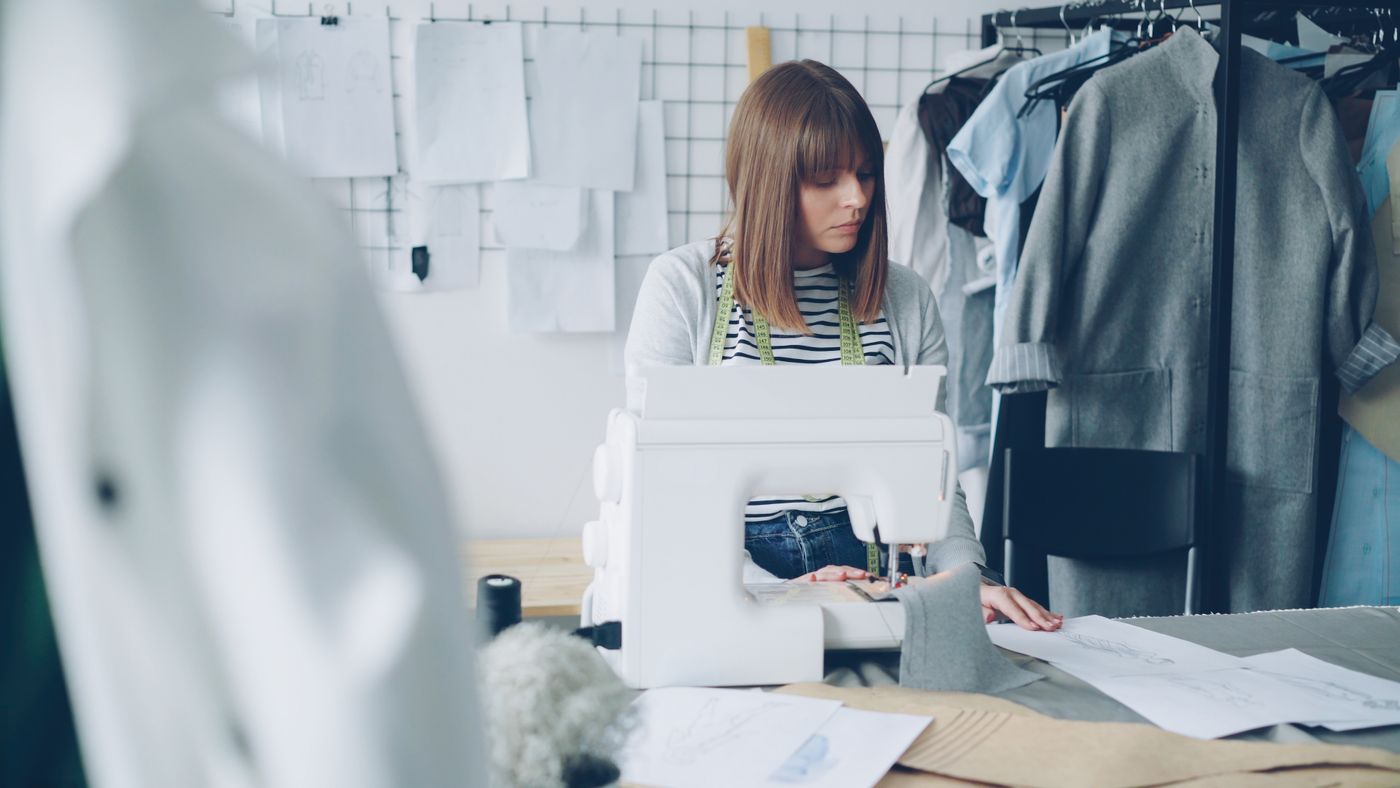 Fashion designer sewing in a studio