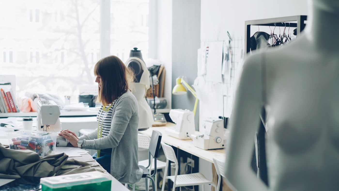 A designer working at a machine in a bright, quiet studio
