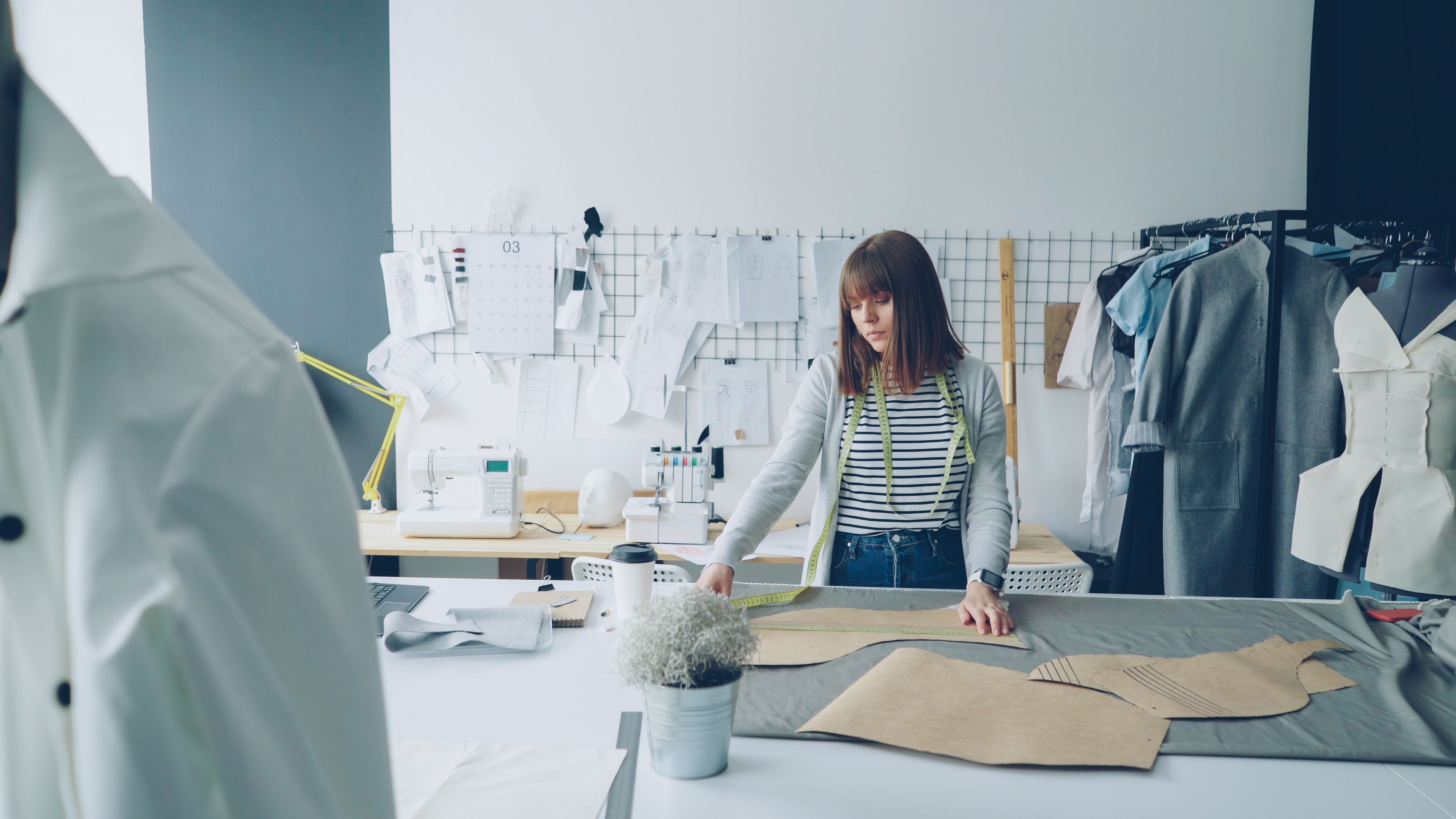 Tailor working on fabric with measuring tape