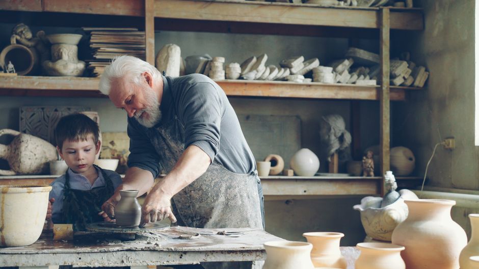 How Ceramic Nonstick Cookware Solves Safety Concerns Compared to Teflon A grandfather and young boy making pottery together in a cozy studio setting.
