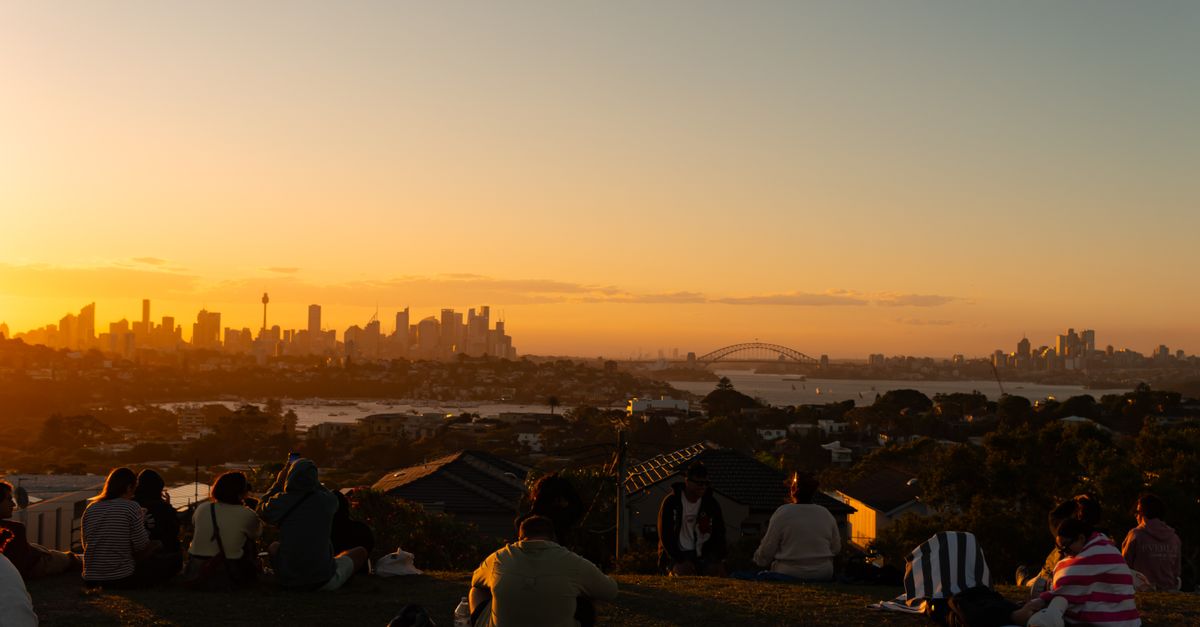 golden hour city skyline at 6pm with people relaxing on rooftop
