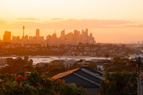 Free Stunning sunset view of Sydney skyline with iconic landmarks and harbor, capturing a serene moment. Stock Photo