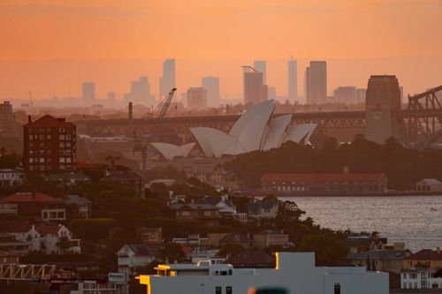 Free A beautiful view of Sydney Opera House and skyline at sunset, showing the architectural marvel and urban environment. Stock Photo