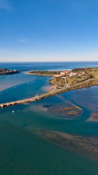 Breathtaking aerial view of Cantabria coastline with blue seas and lush greenery, showcasing natural beauty.